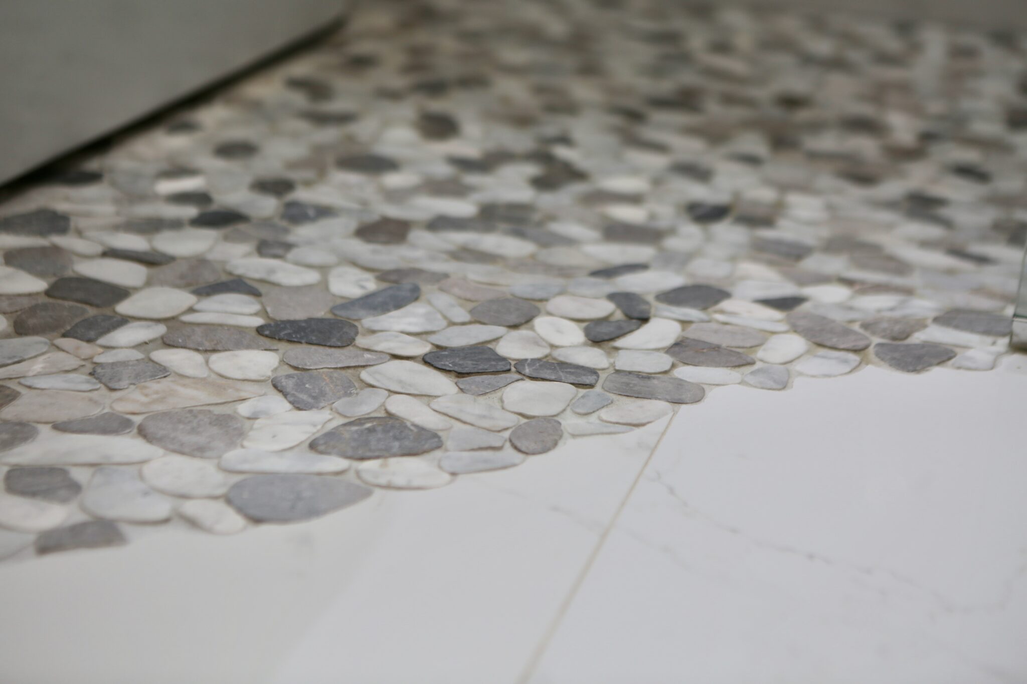 Pebble-style stone tile flooring in shower area